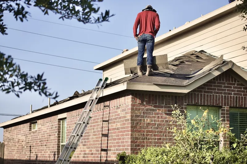 Professional roofer working on a residential roof in Shawsheen Heights